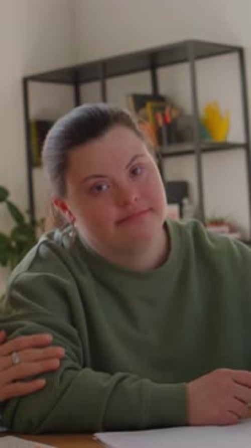 Woman writing at a table at home