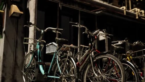 Collection of Vintage Bicycles Parked in an Urban Alleyway During Evening