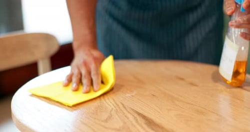 Hands, cafe and cleaning table with spray, cloth or chemical disinfection for hygiene in coffee