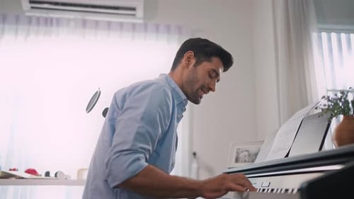 Man Plays Piano and Sings at Home