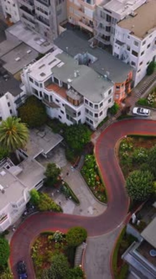 Empty famous Lombard street in San Francisco. Raising over the cityscape into a thick mist.