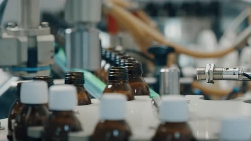 Automated Factory Production Line With Brown Bottles