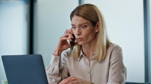 Upset Boss Talking Cellphone at Office Close Up. Sad Business Woman Having
