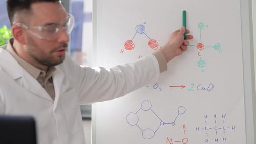 Distance Education, School and Science Concept - Male Chemistry Teacher with Laptop