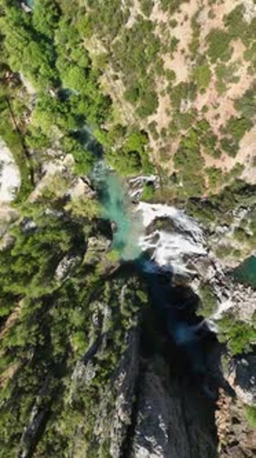 Vertical Video Enchanting Cascade Aerial View of a Magical Waterfall with Azure Waters