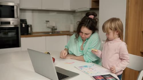 Beautiful Mom Helps Her Young Daughter with Her Drawing