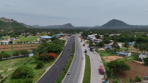 Aerial footage of wind turbines located near the highway, showcasing renewable energy.
