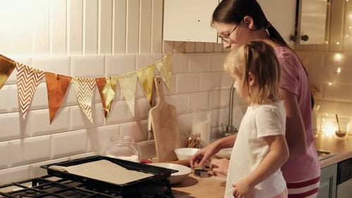 Children Rolling Out Cookie Dough with Wooden Rolling Pin on the Kitchen Countertop Kids Baking
