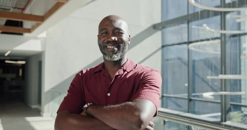 Face, happy and black man with arms crossed in office hallway, confident
