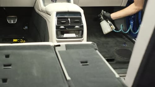 Cleaning a Car Interior with a Spray Tool