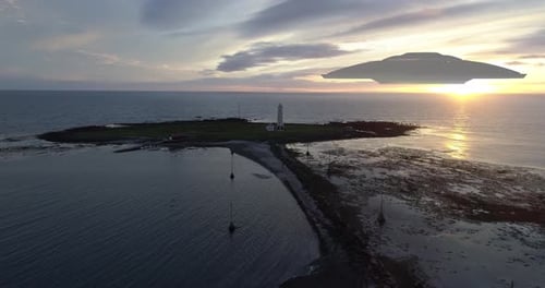 Flying Saucer ufo over the sea at sunset, Aerial view