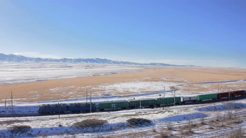the railway and a moving train with freight cars