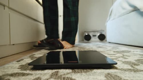 Fitness Routine Results Male Feet On Digital Scales In Gym