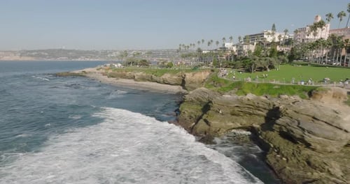 a beach with a body of water and a building