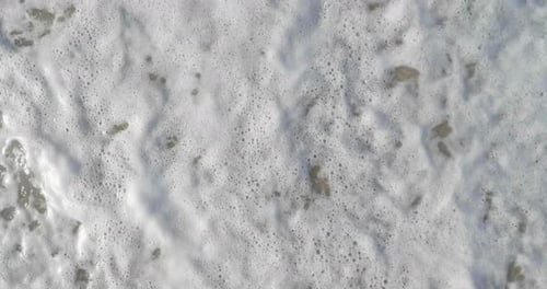 Waves on brown sand, washed off by wave background. Concept: rest, the sea, the beach, the coast,
