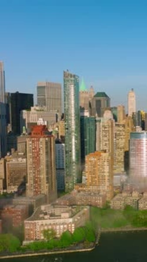 Manhattan island beautiful architecture. Fog coming to the city from blue waters of the river.