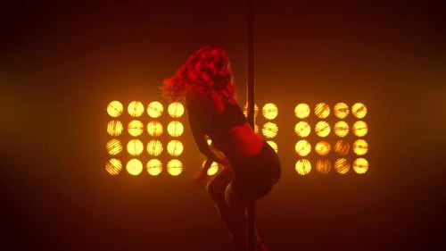 Hot Woman Pole Dancing in Front Bright Spotlights Nightclub. Beautiful Fit Girl