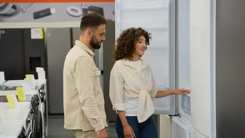 Couple Choosing Discount Refrigerator in Appliance Store