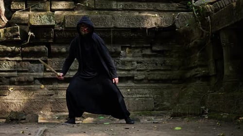 Caped Man Juggling His Sword In Temple Ruin