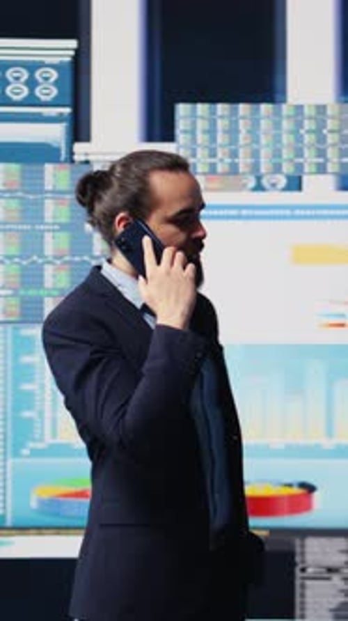 Vertical Video Professional Businessman Answering a Phone Call Surrounded By KPI Metrics