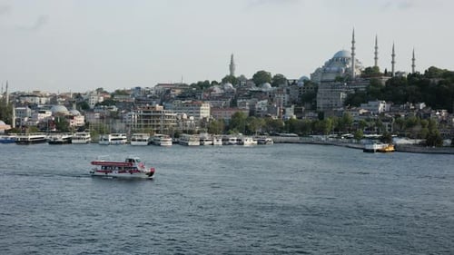 Istanbul cityscape with boats on the Bosphorus and Suleymaniye Mosque in the background