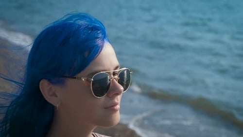 A Teenager with Blue Hair on the Seashore