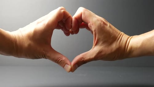 Two Hands Forming a Heart Shape