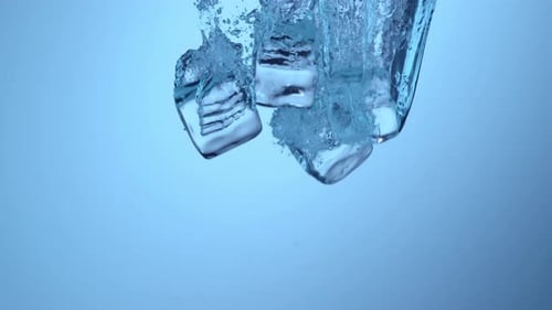 Ice Cubes Dropping Into Water With Bubbles