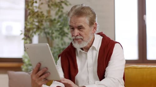 Senior Man Using Tablet at Home