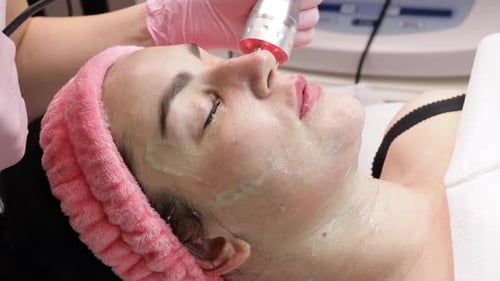 Woman Receiving Facial Treatment in a Bright Hospital