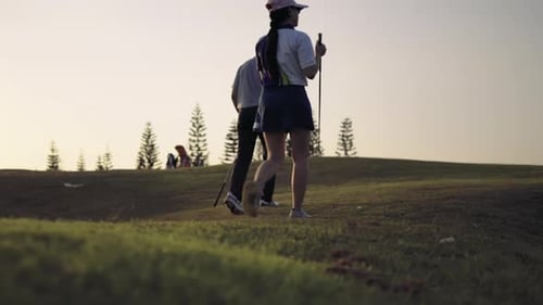 Couple Golfing player talking about nice shot in golf course after hit the golf ball to hole for sco