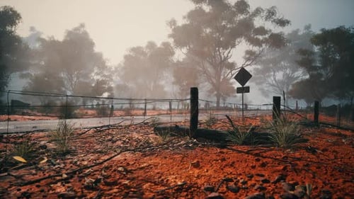 Dirt Field With Fence and Sign