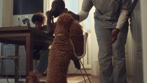 Family at Table with Dog and Medical Professional