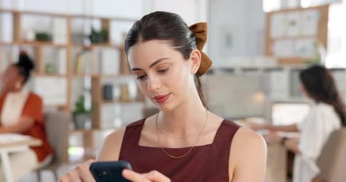 Woman Uses Phone in Open Office Environment