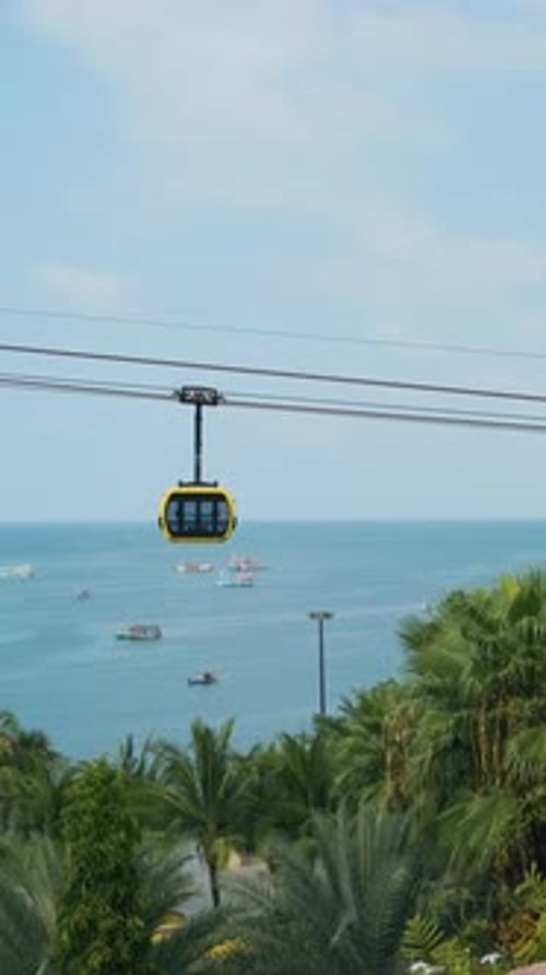 Modern Cable Car Gondola Ride Over Tropical Seaside with Fishing Boats and Turquoise Sea on Phu Quoc