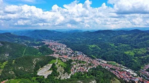 View From Rock to Town of Smolyan with Meadows for Cattle Walking and Houses Between Mountain Range