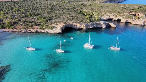 Explore Cala Varques in Majorca's Crystal Clear Waters with Majestic Sailing Boats