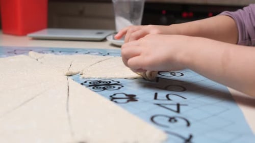 Child Hands Making Crescent Rolls in the Kitchen