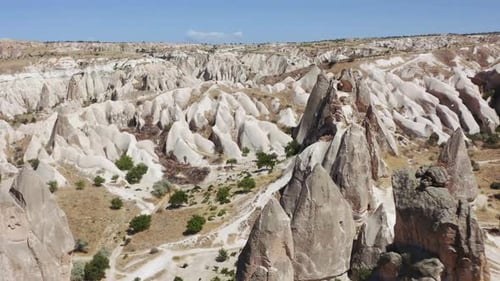 Aerial view of the town Göreme with rock houses in front of the spectacularly coloured valleys nearb