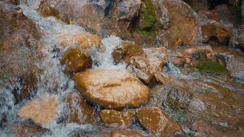 Relaxation Background Flowing Mountain Stream Water on Orange Rocks Slow Motion