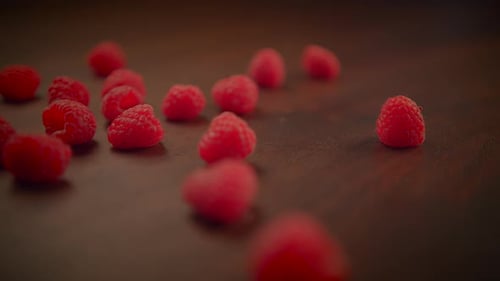 Close Up of Raspberries on Dark Surface