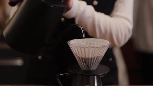 Woman Pouring Hot Water Over Coffee Filter