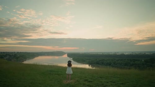 Woman in White Dress Reflecting By Tranquil Lake at Sunset