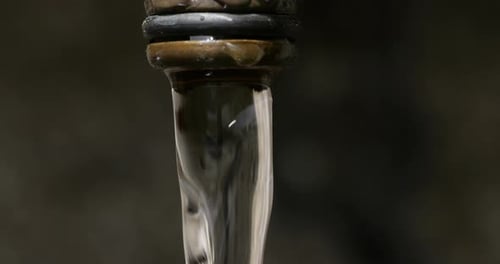 Water Flowing From a Copper Tap