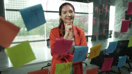 Woman Brainstorms Business Ideas in Modern Office