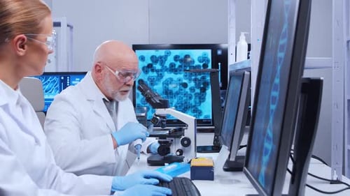 Scientists Working with Microscope in Modern Laboratory
