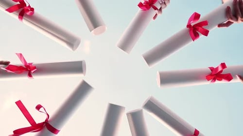 Graduates Join Their Diplomas in a Circle Against the Sky