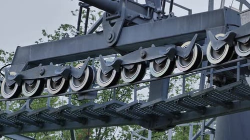 Closeup of a Ski Lift Chairlift Mechanism with Pulley Wheels on a Steel Cable