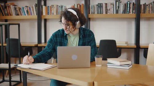 Young Guy College Student Sit at Desk Use Pc Laptop Computer Watching Distance Online Learning
