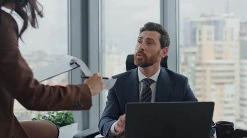 Confident business partners discussing official contract in luxury modern office